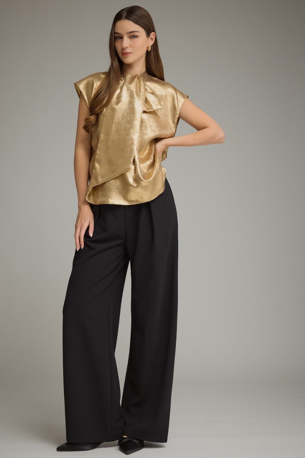 Solid cap sleeve top with a high neckline and oversized bow detail at front. Back keyhole with button closure.
