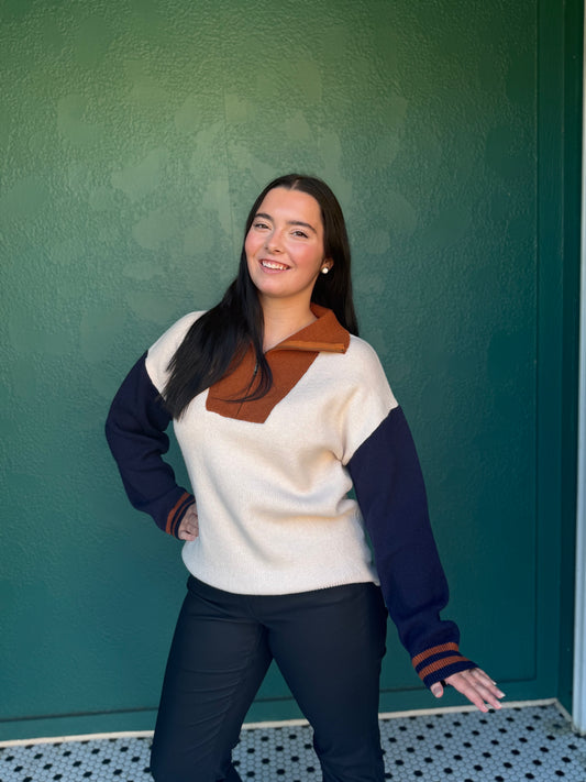 Color blocked sweater top with front zipper.