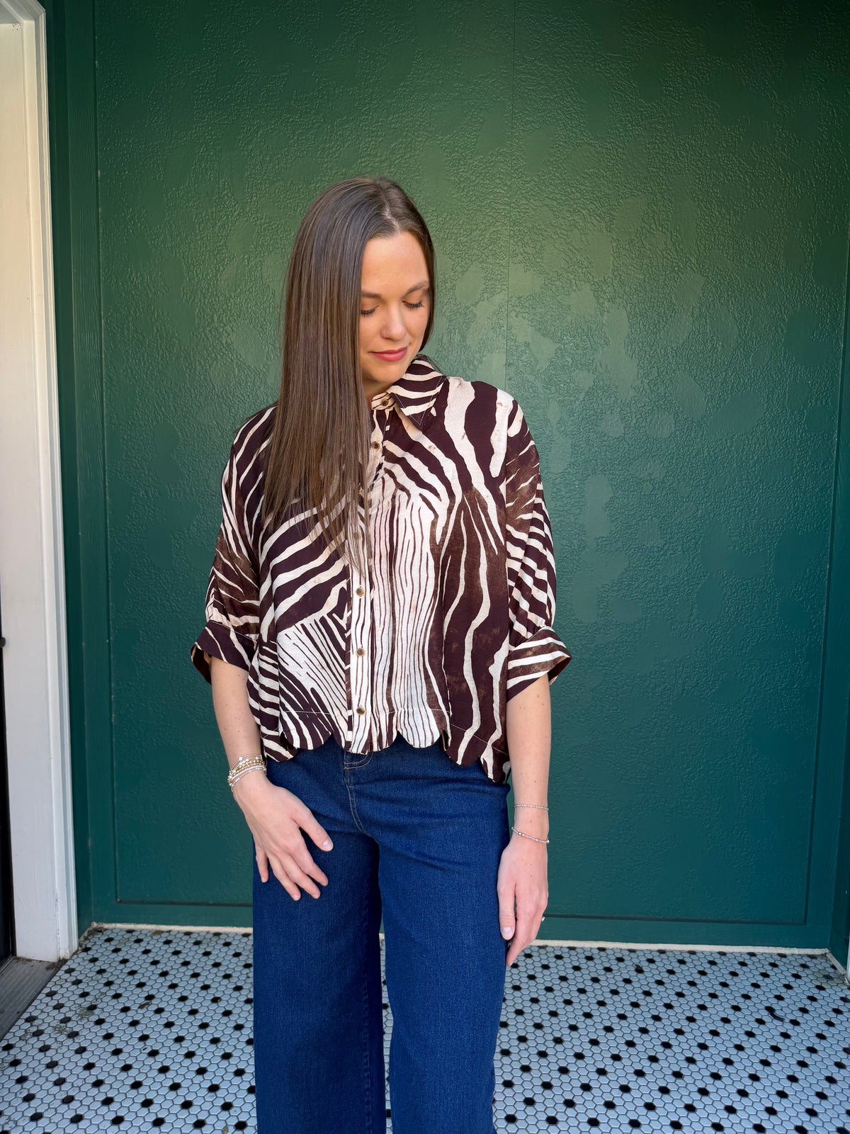 Zebra print poncho sleeve top with a shirt collar and button closure at front